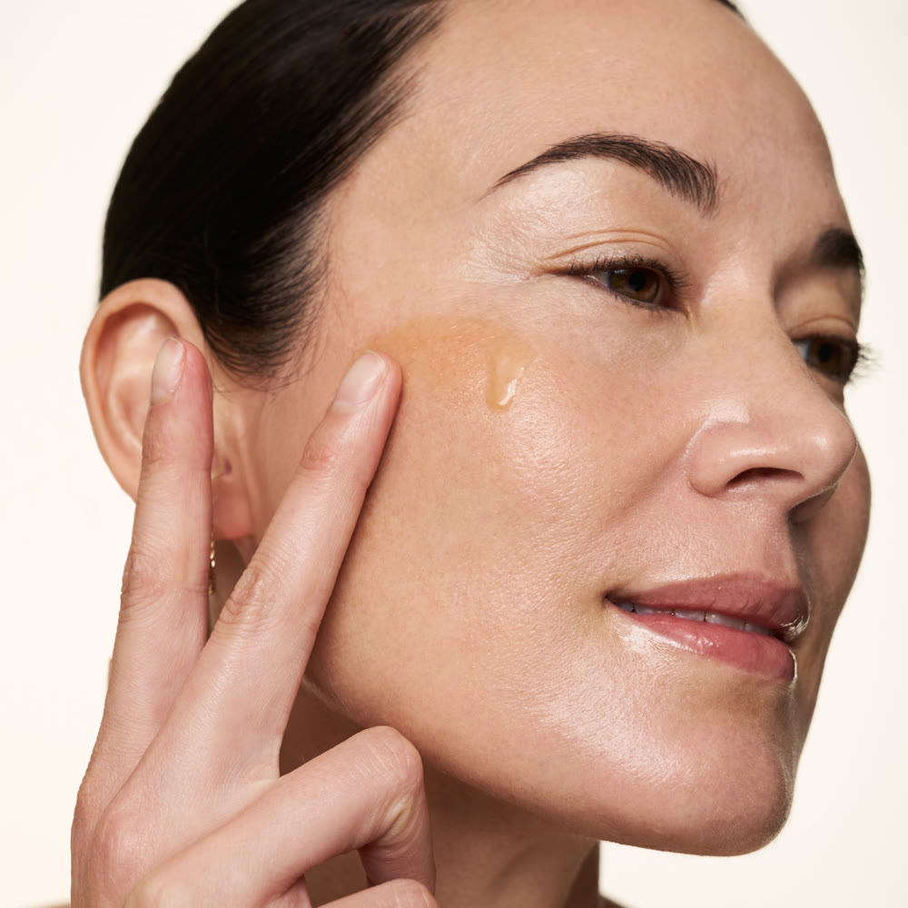 Golden Vitamin C serum drop on skin